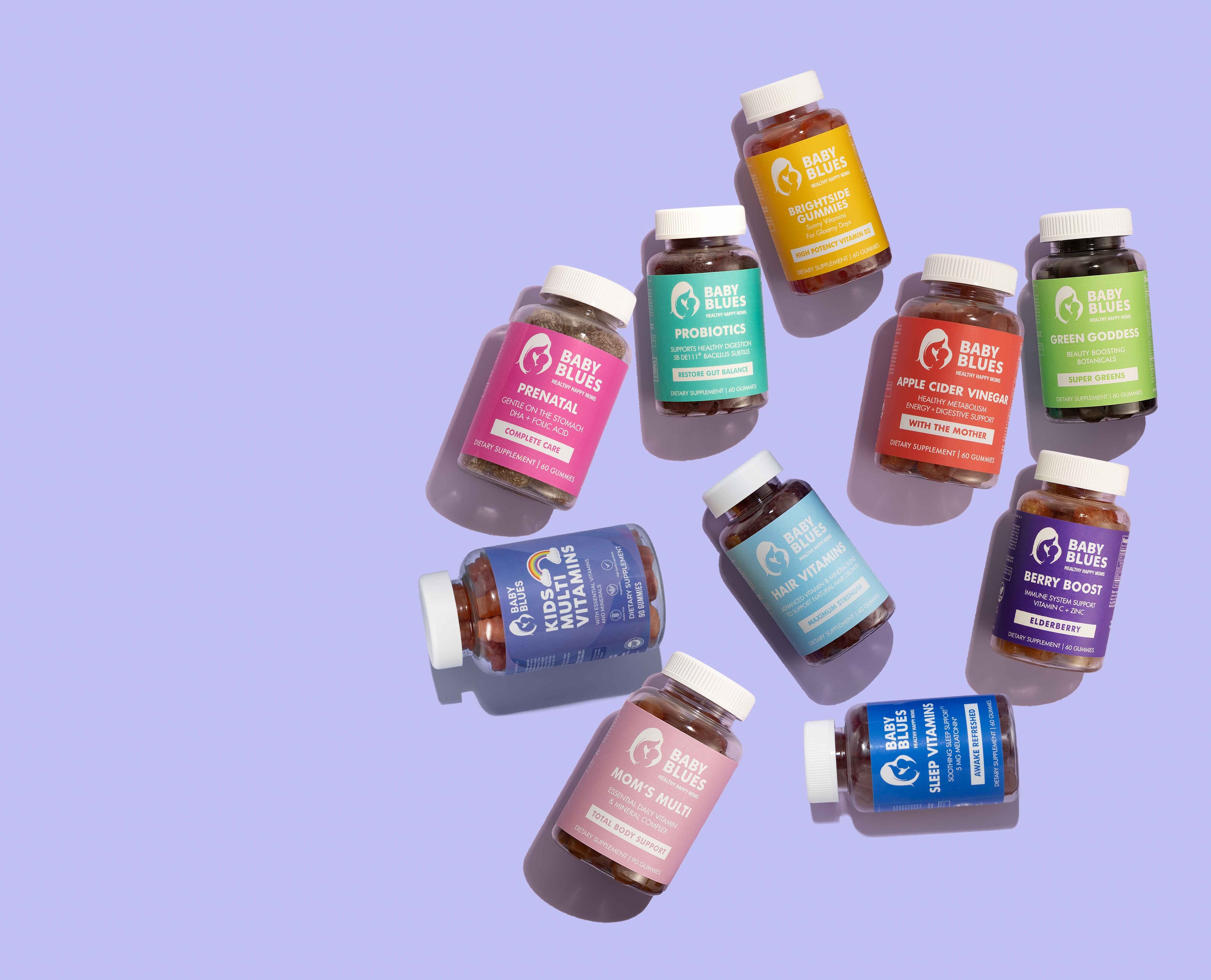 Baby Blues supplement lineup arranged on a lavender background showcasing vitamins for moms, kids, beauty, and wellness